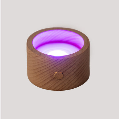 Wooden container with a purple light on a gray background